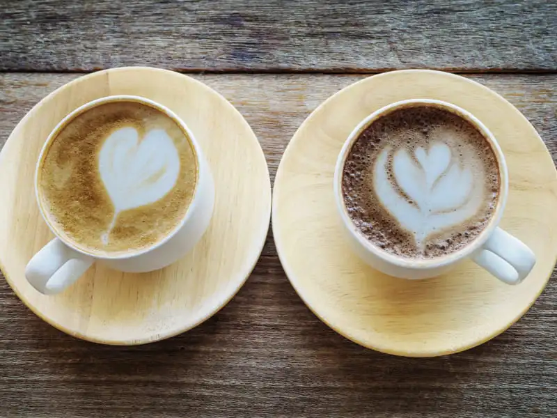 Flat White Coffee: Your Super Easy Guide to This Tasty Drink Flat white coffee and cappuccino side by side on wooden table, showing smooth microfoam and rich espresso layers for easy comparison.