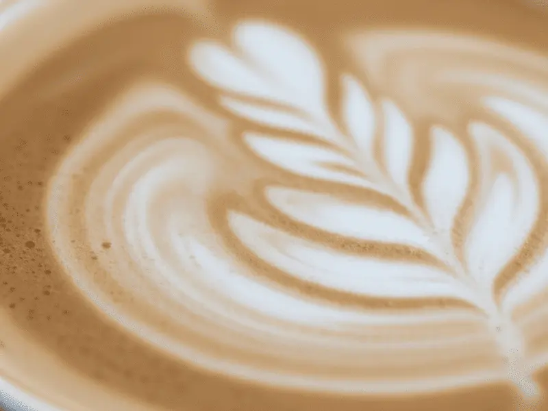 Flat White Coffee: Your Super Easy Guide to This Tasty Drink Intricate microfoam latte art in a flat white coffee showcasing silky tiny milk bubbles